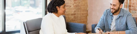 A case manager discusses documents with a client living with HIV