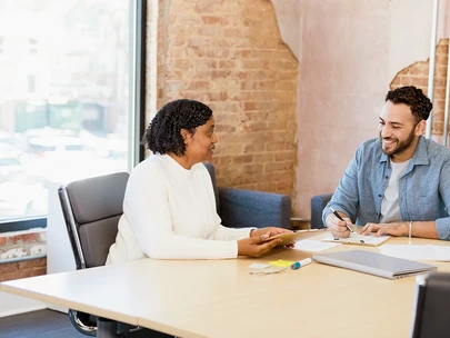 A case manager discusses documents with a client living with HIV